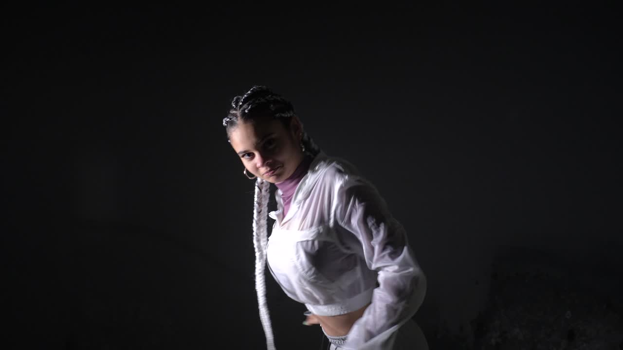 Woman with braids in a white jacket