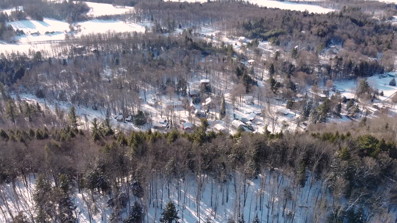 Snowy forest homes in Sherbrooke, peaceful winter village from above