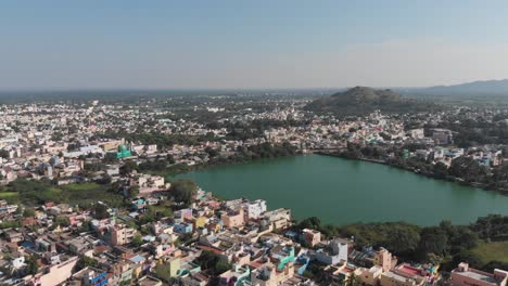 beautiful green lake surrounded by large indian city during sunny day