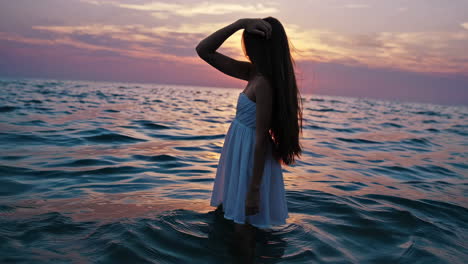 Woman's Silhouette in Ocean at Sunset