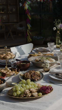 an outdoor table set with a variety of dishes for a festive meal