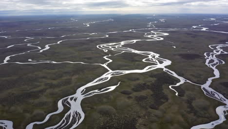 aerial view of winding rivers in a vast flat landscape