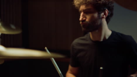 musician playing on drum kit in studio