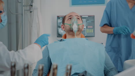 patient with oxygen mask receiving anesthesic in dentistry cabinet