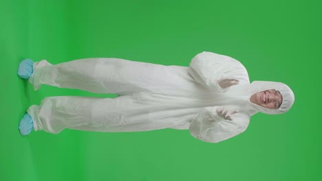 full body of asian man wearing personal protective equipment uniform ppe and clapping his hands in the green screen studio