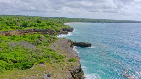 Waves-Crashing-On-Rocky-Cliffs-In-Boca-de-Yuma,-Dominican-Republic---aerial-drone-shot