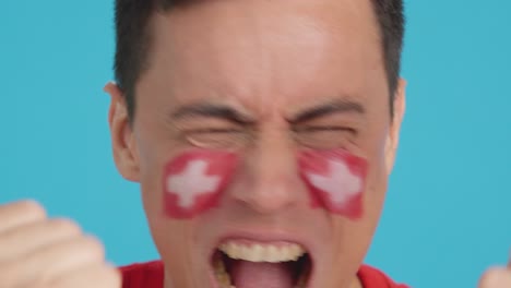 Close up of a man supporting swiss team