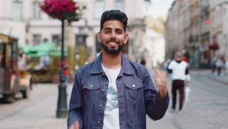 young man shouting celebrating success winning goal achievement good victory news in city street