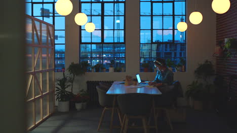 woman working late in a modern office space at night