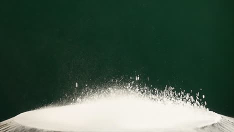 jumping flour on moving subwoofer on green background