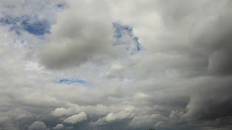 fast moving rain clouds with patches of blue sky coming through in cinematic closeup detail texture view