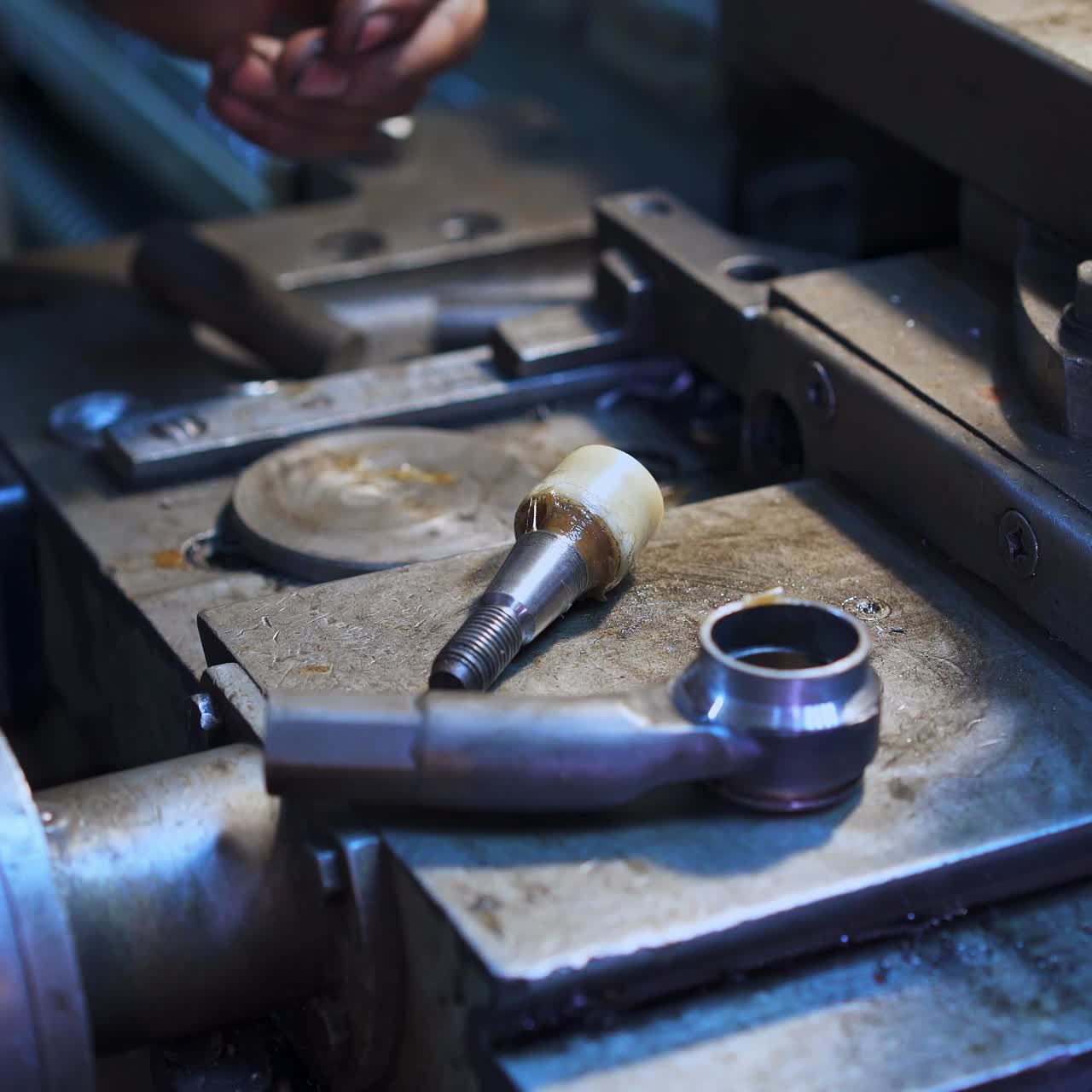 Hands of turner taking two details and sticking them together. Turner making details in his workshop. Turning lathe backdrop