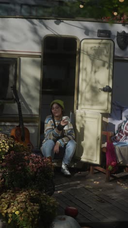 woman relaxing in a campervan on a sunny autumn day