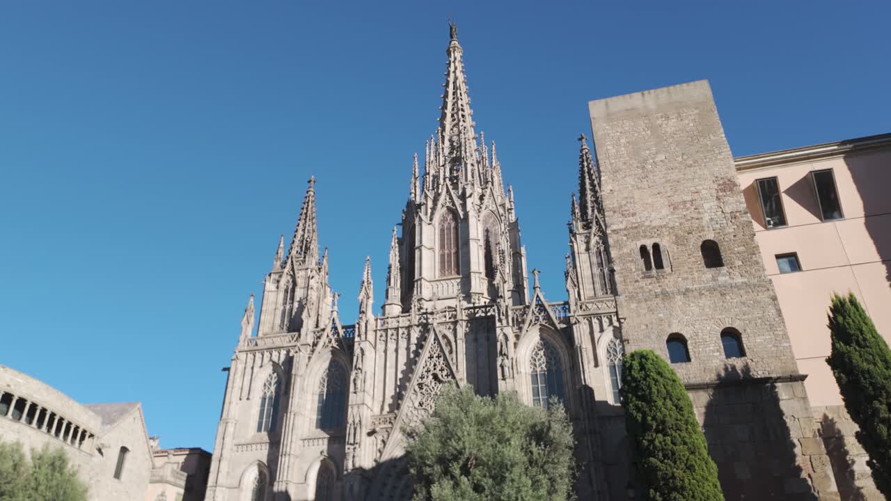 A grand view of the Barcelona Cathedral under a clear blue sky, exuding historic charm