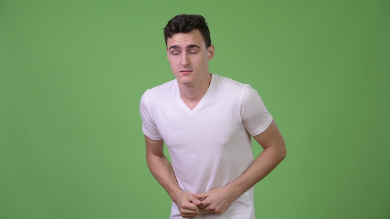 Young handsome man having stomach ache