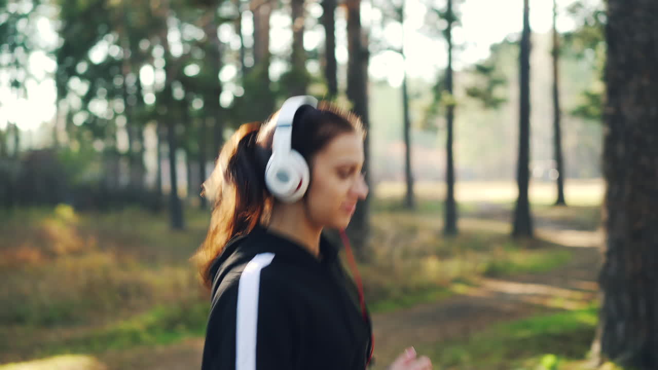Woman Running in a Forest with Headphones
