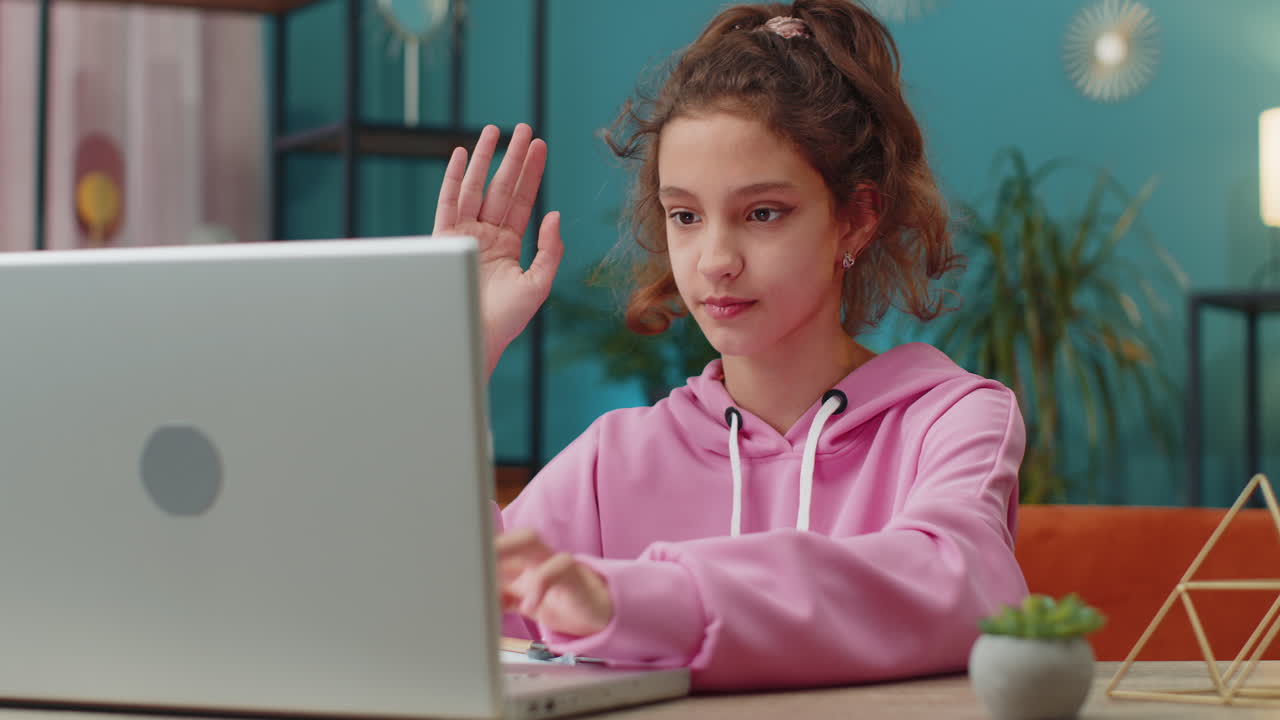 Preteen school girl using laptop for online lesson doing homework distance learning education