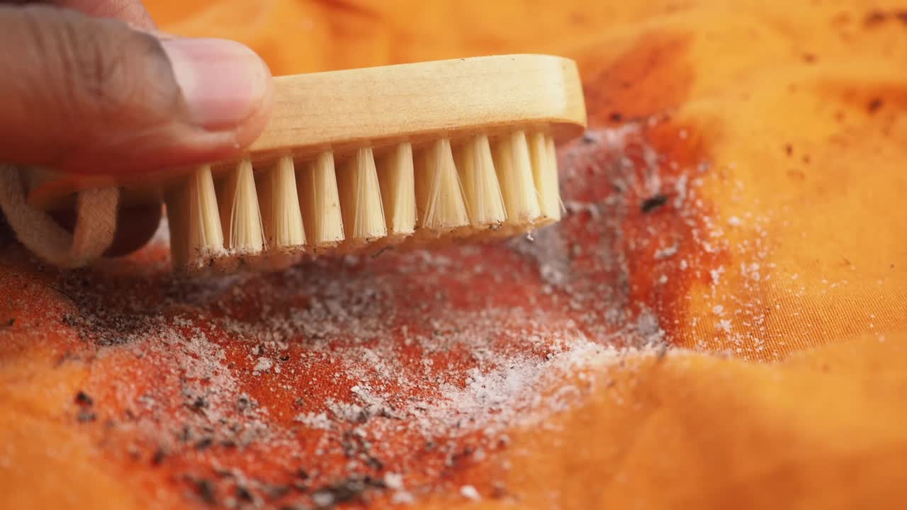 Cleaning a Stain from Outdoor Clothing with a Brush