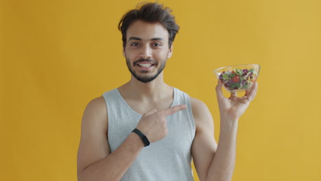 man holding a salad bowl