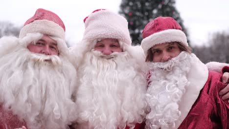 santa claus wishes children a happy new year and merry christmas magic time for kids santa claus wishes children a happy new year and merry christmas the men dressed in santa claus costumes christmas characters magic time for kids