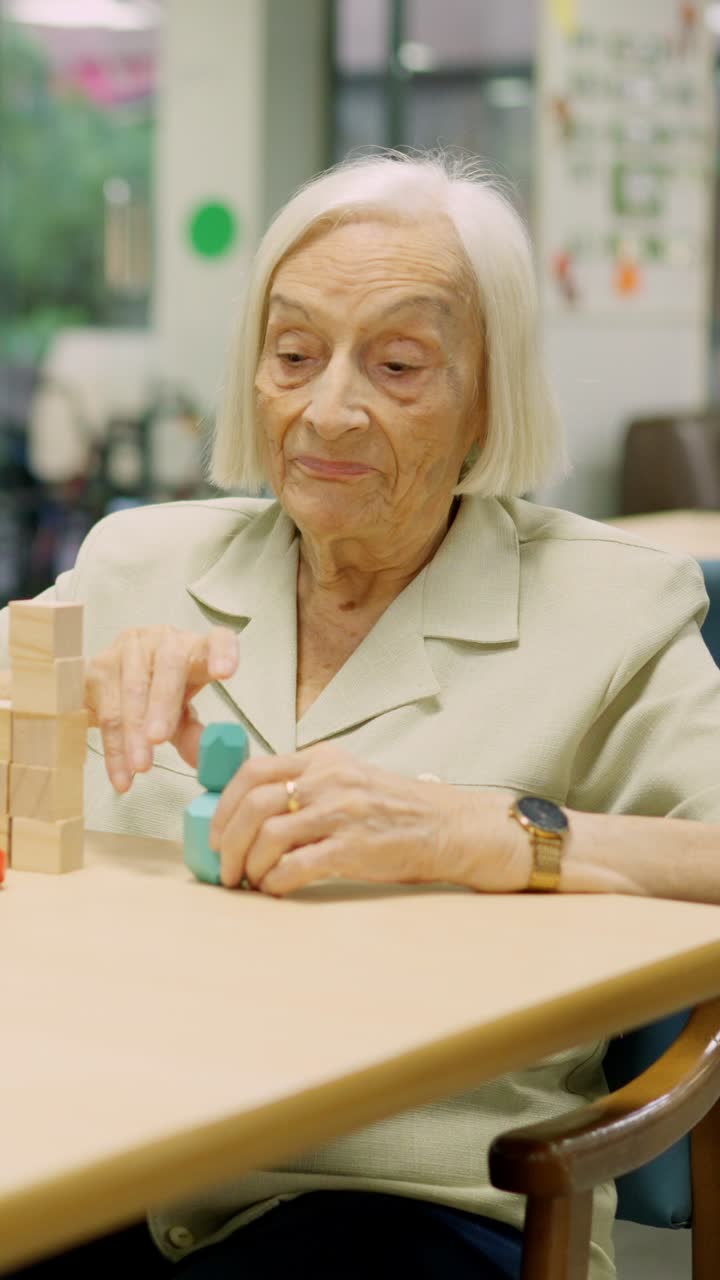 Elderly Woman Stacking Wooden Blocks for Cognitive Therapy