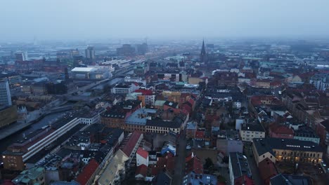 jib down of historical buildings in the beautiful city center of malmö, sweden on a misty morning
