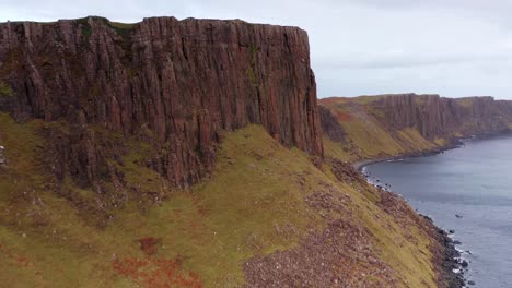 aerial drone flyover of lealt fall cliffs near the brother's point in skye scotland autumn