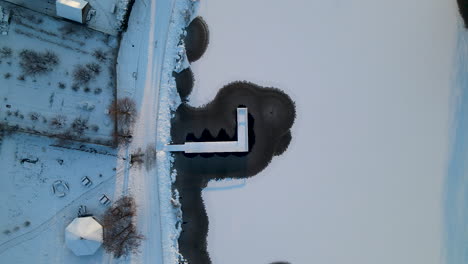 Jetty-On-Frozen-Pond-In-The-Town-Of-Gorowo-Ilaweckie-In-Poland-During-Winter-Season