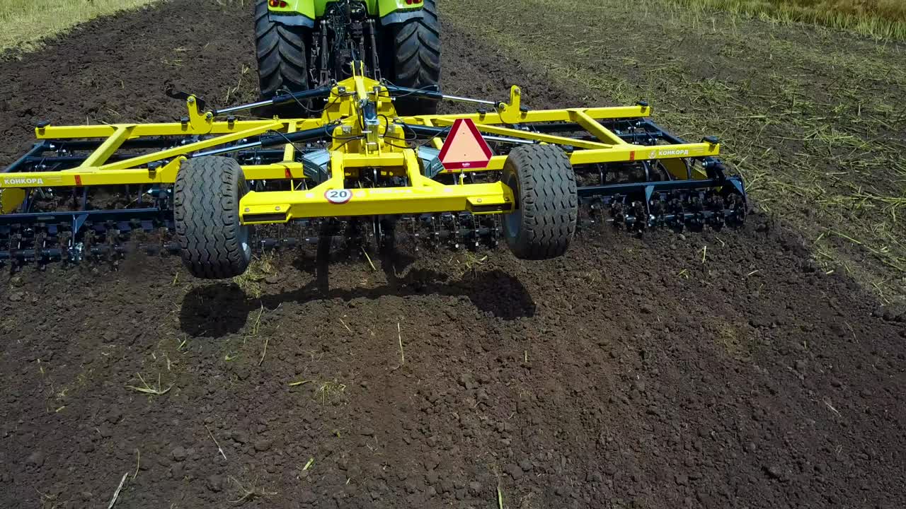 Tractor Working In The Agricultural Field. VINNITSA, UKRAINE - JULY 2017: Agricultural equipment ready for ploughing the fields