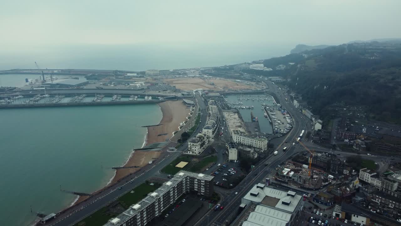 Aerial View of Coastal City with Harbor and Beach