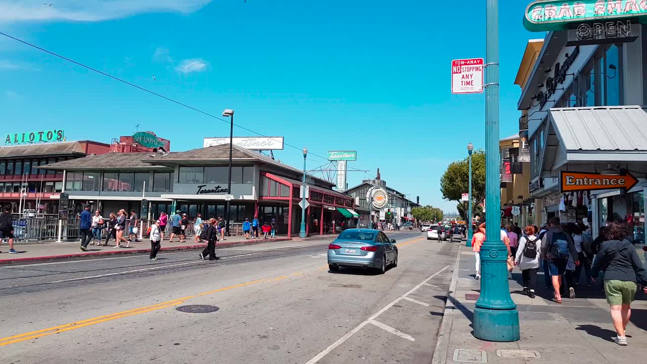 Gimbal stabilized shot walking backwards on Jefferson Street away from Fisherman's Wharf in San Francisco, California, USA