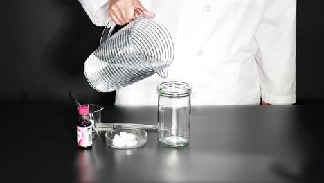 scientist pours water on dry ice