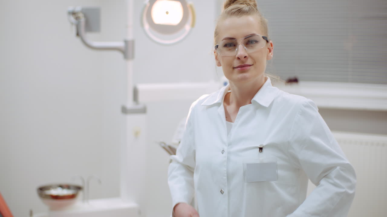 Young Positive Female Dentist Smiling At Dental Clinic