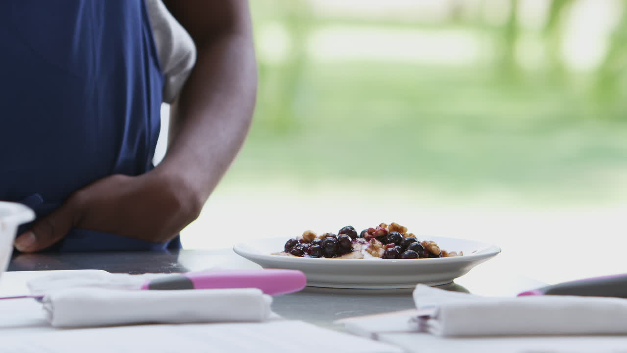 Close Up Of Woman Taking Photo Of Meal On Mobile Phone For Social Media In Cookery Class