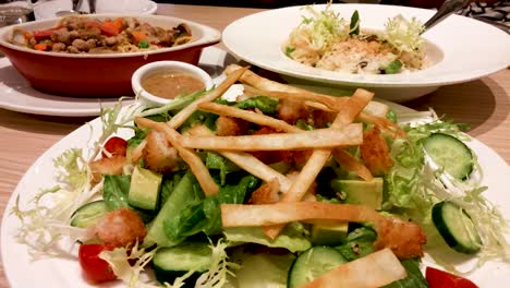 fried fish with avocado salad, garlic minced meat spaghetti, truffles italian rice in an italian restaurant