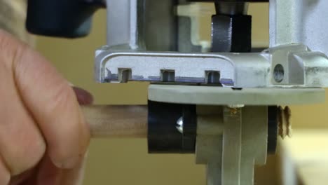 close up of making bolt threads on wooden dowel using electric router and jig