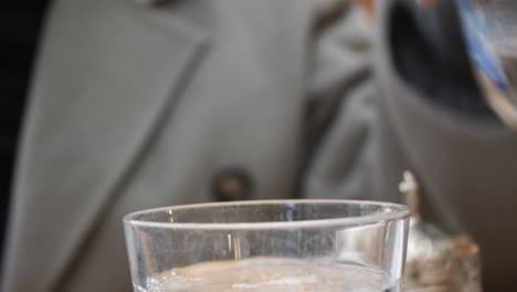 pouring water from a bottle into a glass