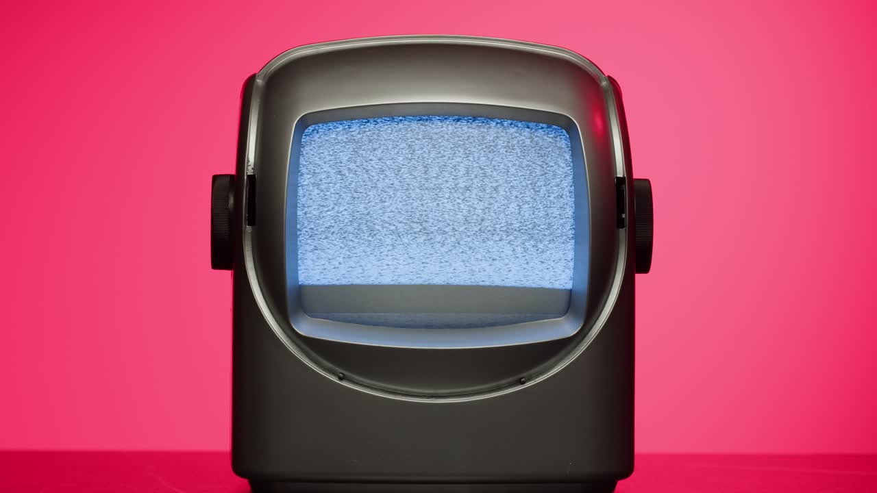Retro TV, vintage television In a nostalgic setup, a retro TV displays grain on screen, scary halloween night device good for chroma key and green screen. High quality 4k footage