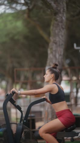 woman exercising on an air bike outdoors