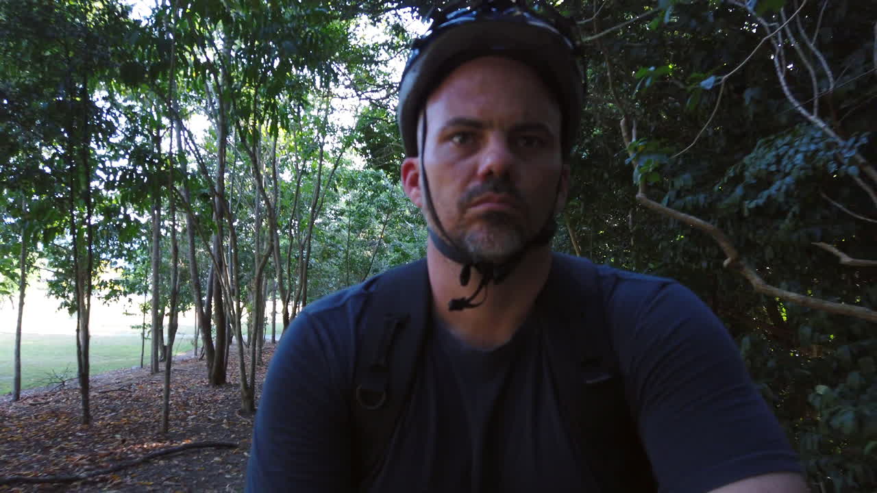 guy riding a bike and smiling enjoying himself in slow motion