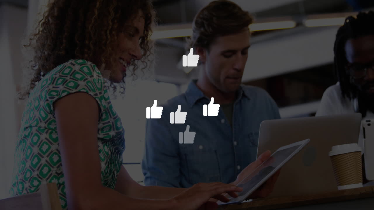 Team collaborating on social media marketing in coworking space, using floating thumbs?up icons