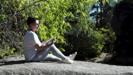 person reading in a forest