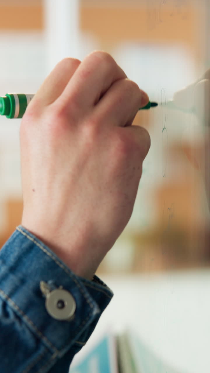 Close-up of Hand Writing on Whiteboard with Green Marker