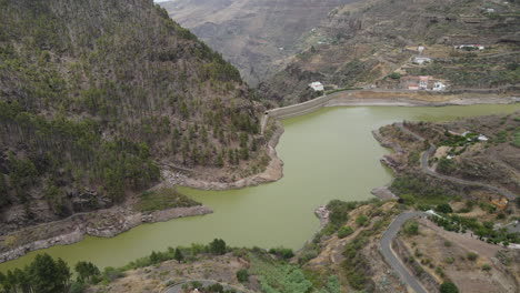 los perez dam: aerial view traveling in to the dam located in artenara, gran canaria island on a sunny day