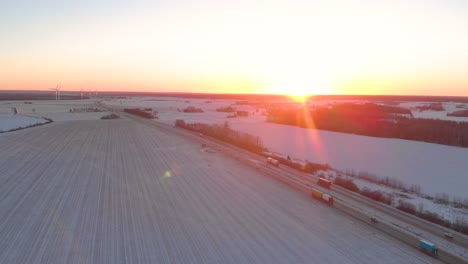 sunset over fields and highway in winter time sweden