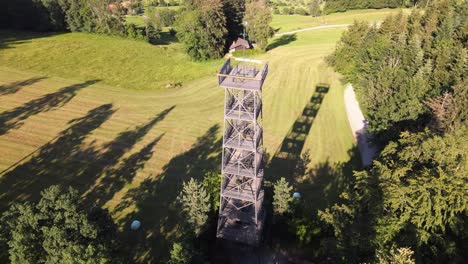 Aerial-close-drone-shot-flying-around-the-Pfannenstiel-observation-tower-in-the-canton-of-Zürich,-Switzerland