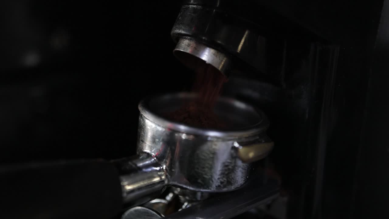 Barista's Point of View Closeup: Fresh Coffee Grounds Being Transferred to Portafilter