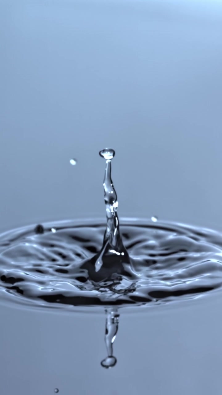 Slow Motion Water Drop Creating Crown Splash and Ripples