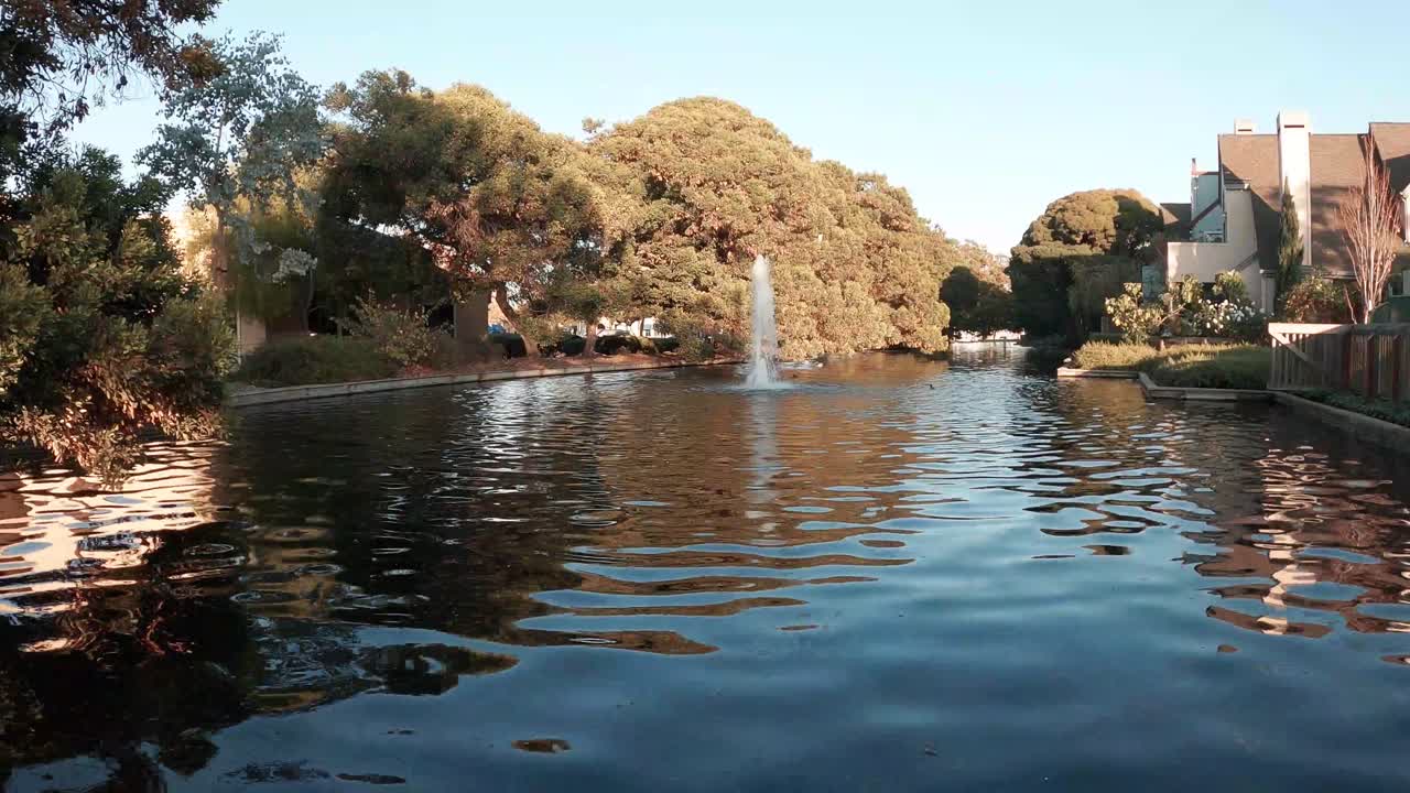 A small fountain in a cove where the bay meets the surrounding land.