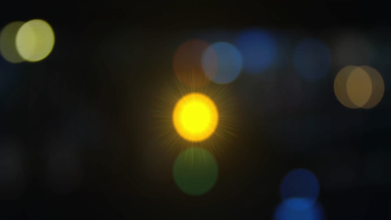 Animation of spots of light over traffic lights changing